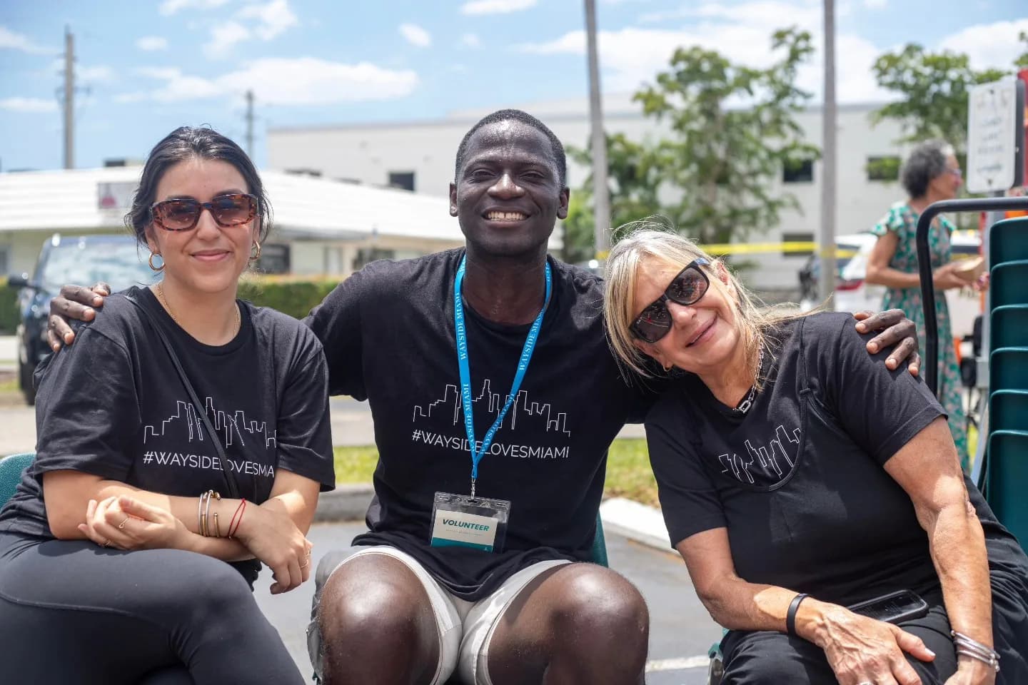 Three Wayside volunteers in #WaysideLovesMiami shirts at a community serve day