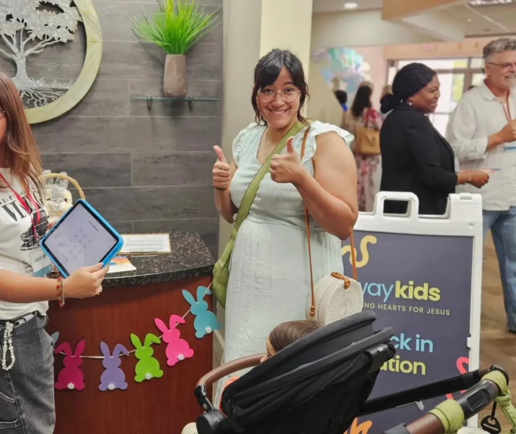 Families at the WayKids check-in station
