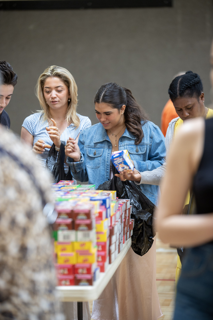 Young adults gathering around a table of supplies